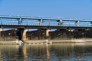 side view of river dam with road on top of the dam
