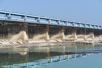 side view of river dam with road on top of the dam