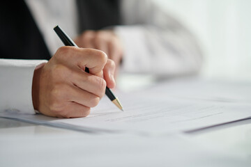 Closeup image of social working signing document