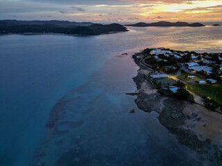 Aerial orange sunset showing the beach and town of Torres Strait