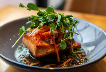 Grilled salmon with black rice and herbs