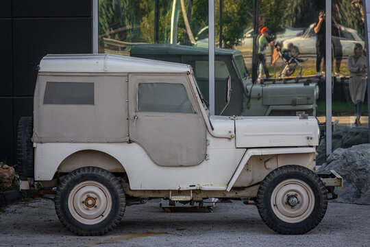 Antalya, Turkey - February 18, 2023:   beige Willys Jeep   is parked  on the street on a warm   day