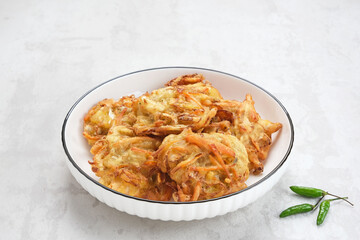 Bakwan sayur or bala-bala or vegetable fritter, Indonesian snack made from flour, cabbage, carrots and bean sprouts, served with chili
