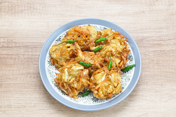 Bakwan sayur or bala-bala or vegetable fritter, Indonesian snack made from flour, cabbage, carrots and bean sprouts, served with chili
