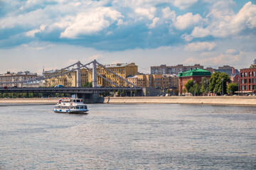 Naklejka premium Krymsky Bridge or Crimean Bridge in Moscow and Cruise ship sails on the Moscow river