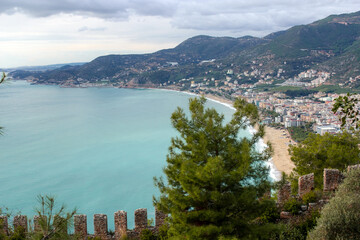 Fototapeta premium Top view of the bay area, old city, fortress, sea and mountains in Alanya, Turkey