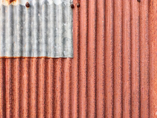 Closeup old and rusty corrugated zinc sheet wall, grunge background metal texture