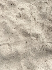 A close up of a sand with a small imprint on it
