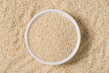 white sesame seeds in plate background.