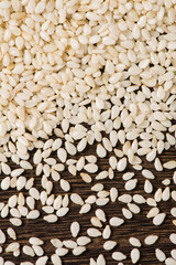 closeup of white sesame seeds on wooden table
