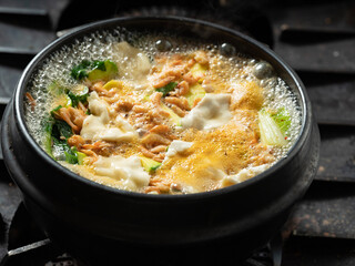 Stew boiling in an earthenware pot	