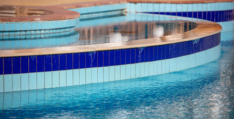 Swimming pool with blue water as a background.