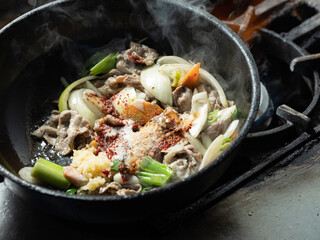 Stir-fry meat and vegetables in an iron skillet