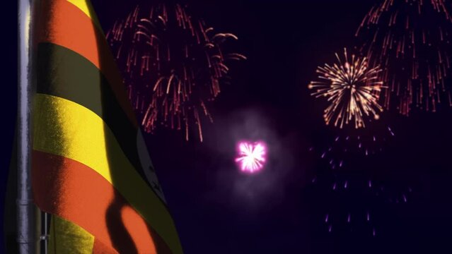 hanging Uganda flag on fireworks sky bokeh backdrop