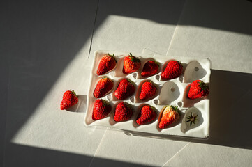 Sweet berry in a package, a gift. Strawberries in insulated white packaging.