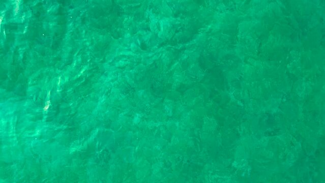 Beautiful low to mid altitude drone view of Lake Attersee, Upper Austria, Europe, on a dark, cloudy, cold early spring day - camera looks down, then pans up to horizon flying forward