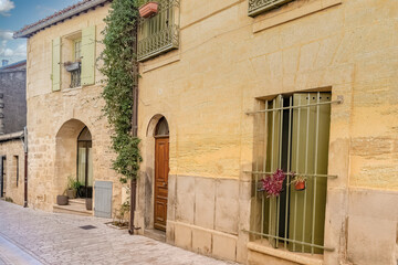 Fototapeta na wymiar Uzes in France, old facades in the historic center, typical street 