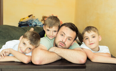 happy man with three children boys