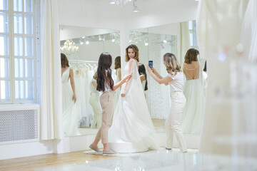 A Bride-To-Be shopping for a wedding dress in a Bridal Boutique.