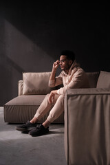 guy is sitting on the sofa. Fashion wallpaper. Hype sneaker.