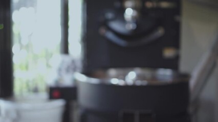 Blurred of coffee beans in roasting machine with the professional coffee roaster.