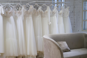 Fototapeta na wymiar Collection of wedding dresses in the shop