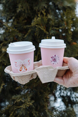 hand holding cups of coffee