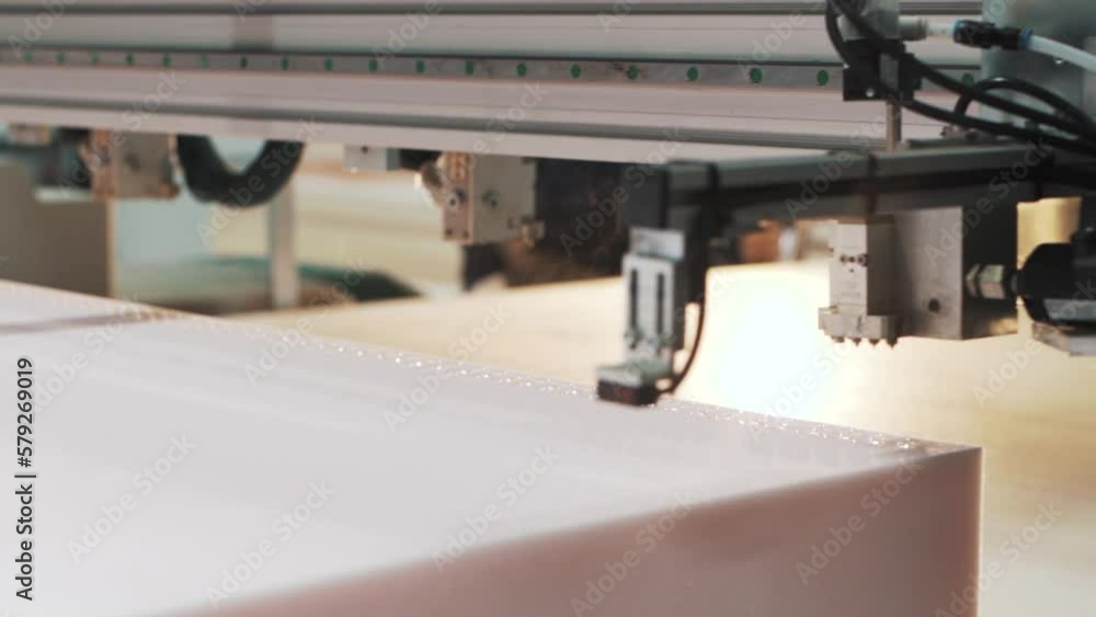 Aufkleber close-up shot of a factory machine automatically applying glue to the material for making a mattress