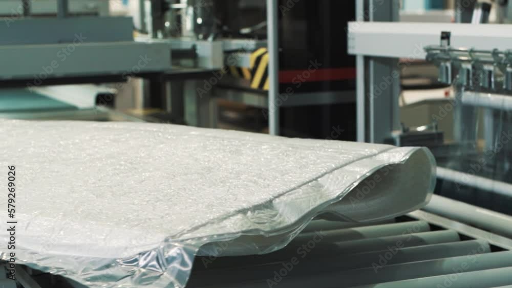 Poster close-up of a factory automated linear packaging line for textile products