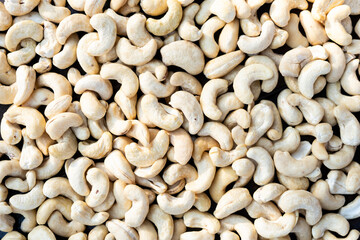 Raw cashew nuts on a wooden table close-up