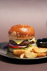 Burger and potatoes fries. Hamburger with cheese