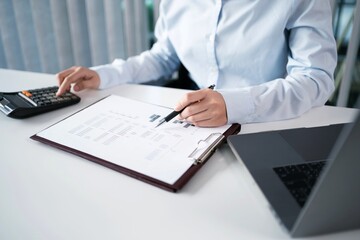 Fototapeta premium Asian Woman working by using a laptop computer&nbsp;Hands typing on keyboard. Working at office professional investor working new start up