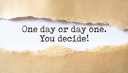 'One day or day one. You decide' written under torn paper.