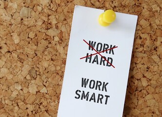 Pinned note on board with text WORK HARD (red crossing) WORK SMART , means smart worker complete...