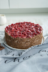 Chocolate crepe cake with cherry on top like black forest cake  close up selective focus