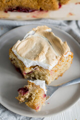 Layer sheet cake with merengue with cut piece of cake white color selevtive focus close up