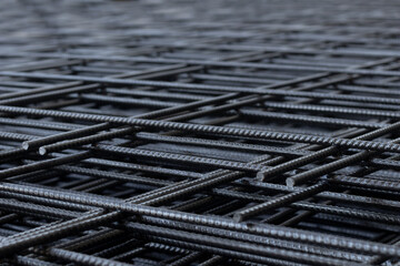 Group of deformed bar or reinforced concrete construction steel net piles on outdoor ground....