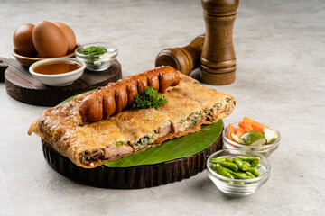 Martabak telur is indonesian street food, made with savory pan fried pastry stuffed with egg, spring onion, meat, sausage, spices and cheese.