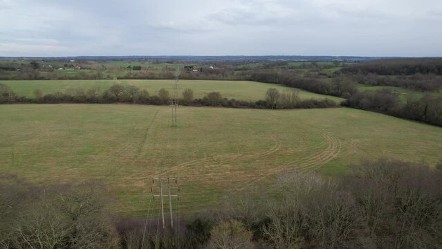 National grid pylons in farm fields Essex UK drone aerial view