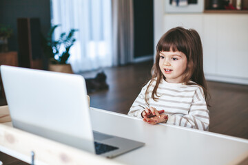 Little girl doing an online finger gymnastics - obrazy, fototapety, plakaty