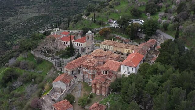 A cinematic fly away tilt reveal shot of Hosios Loukas holy monastery.