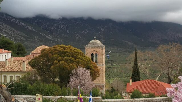 A closer cinematic aerial shot of Hosios Loukas holy monastery.