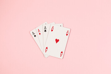 Poker playing cards on pink background
