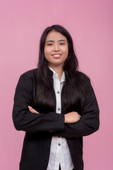 A young southeast asian female employee in a black jacket with arms crossed. Isolated on a light...