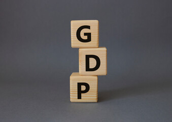 GDP - Gross domestic product symbol. Concept word GDP on wooden cubes. Beautiful grey background. Business and GDP concept. Copy space.