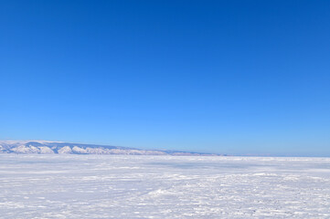 Fototapeta na wymiar View of Frozen Lake Baikal on Sunny Day in Siberia, Russia