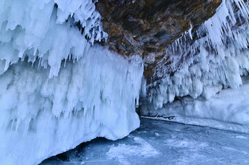 Rock Cliffs with Ice Cave and Icicles on Lake Baikal
