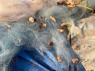 Detail of the meshes of the tangled fishing nets in a coastal village in Goa.