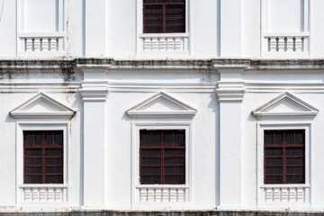 Fototapeta na wymiar Detail of vintage rectangular windows of the ancient Portuguese era St. Francis of Assisi church in Old Goa.