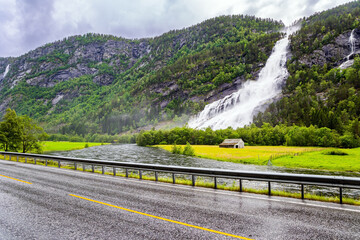 The rain-wet highway glitters